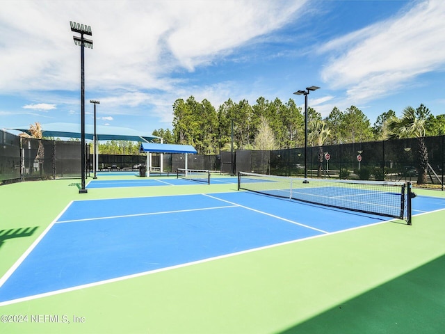 view of sport court with fence