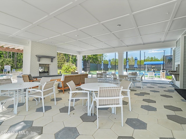 interior space featuring an outdoor brick fireplace and outdoor dining space