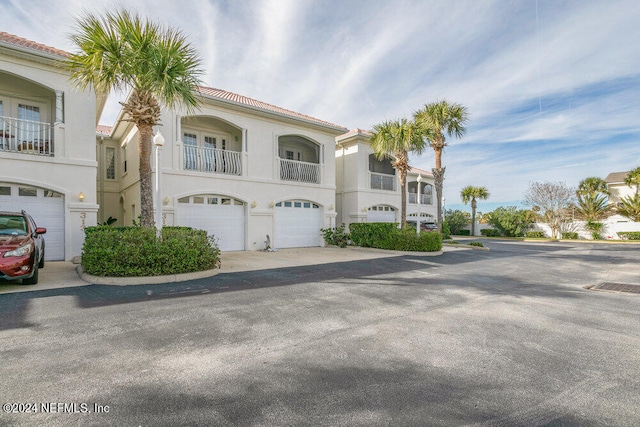 view of front of home featuring a balcony and a garage