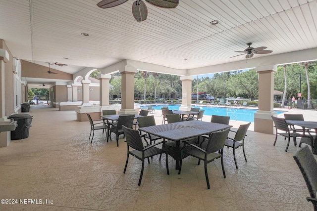 view of patio featuring a community pool and ceiling fan