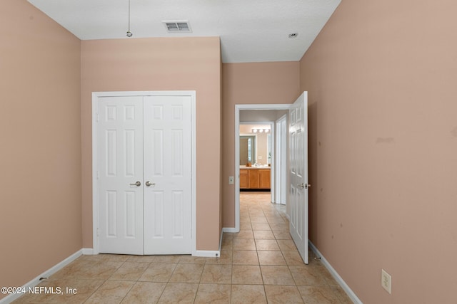 unfurnished bedroom with a closet and light tile patterned flooring