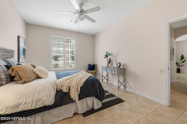 bedroom featuring light tile patterned floors and ceiling fan