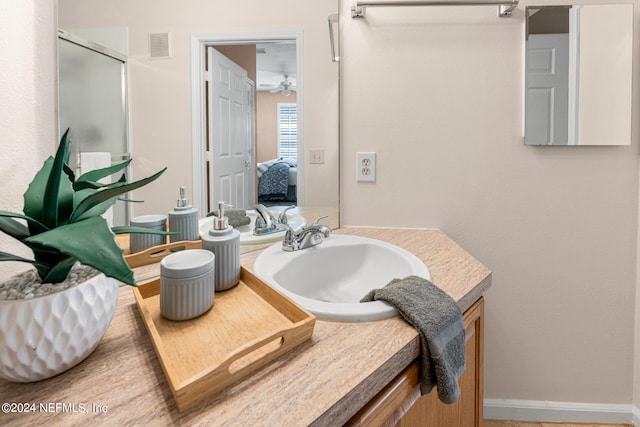 bathroom with walk in shower and vanity