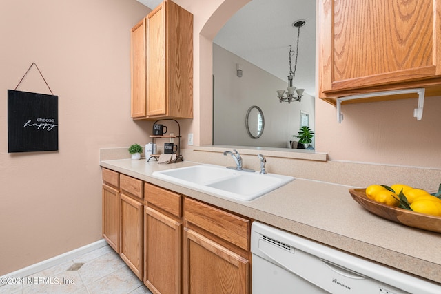 kitchen with light tile patterned floors, white dishwasher, and sink