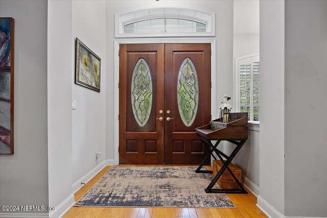 foyer entrance with light hardwood / wood-style floors