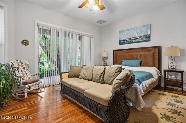 bedroom with access to exterior, ceiling fan, and hardwood / wood-style flooring