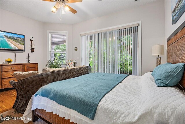 bedroom with hardwood / wood-style flooring, access to exterior, and ceiling fan