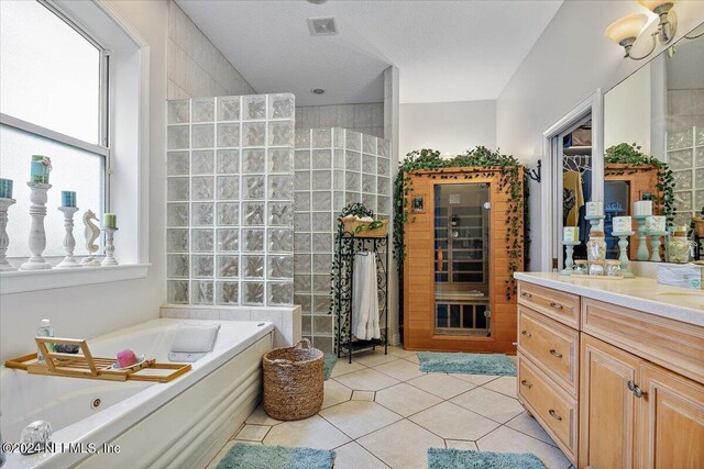 bathroom with a wealth of natural light, vanity, tile patterned floors, and a textured ceiling