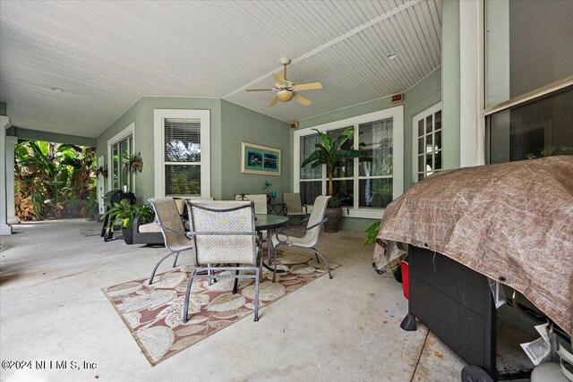 sunroom / solarium with ceiling fan and vaulted ceiling