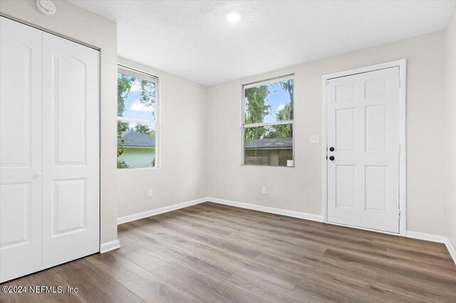 unfurnished bedroom with wood-type flooring