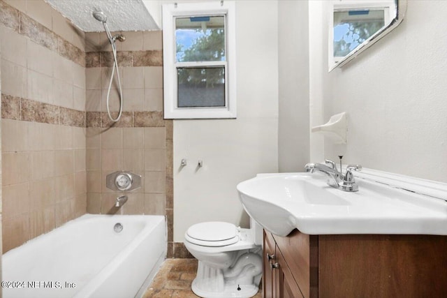 full bathroom with vanity, toilet, and tiled shower / bath