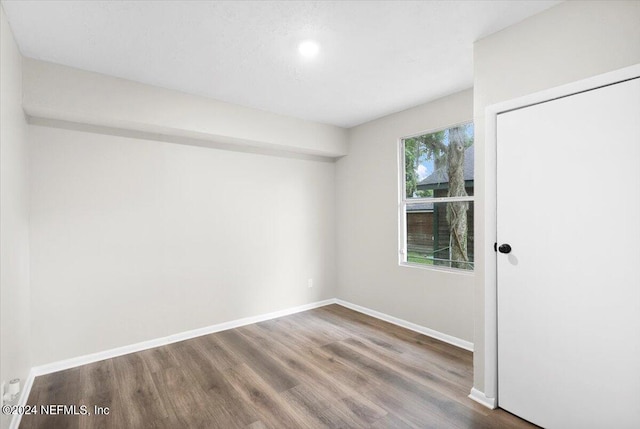 spare room with wood-type flooring