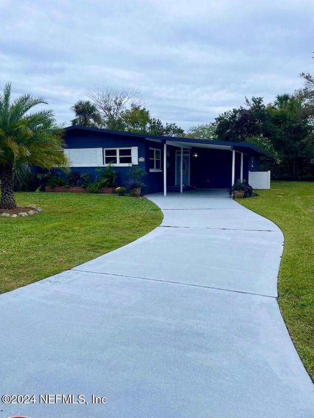 ranch-style home with a carport and a front yard