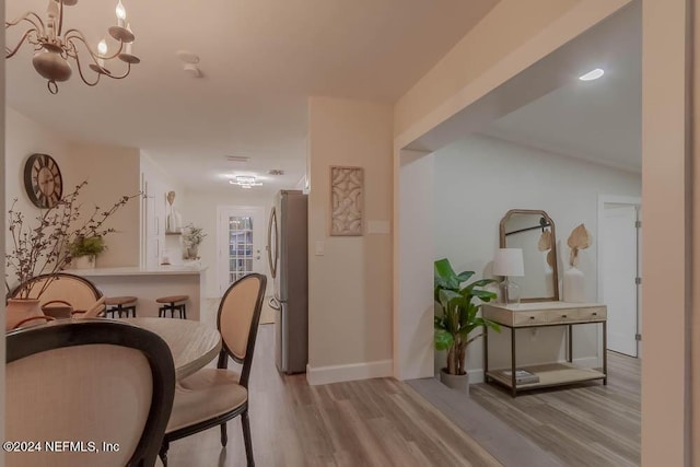 dining room with a notable chandelier and light hardwood / wood-style flooring