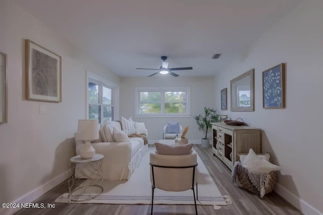 living room featuring light hardwood / wood-style flooring and ceiling fan