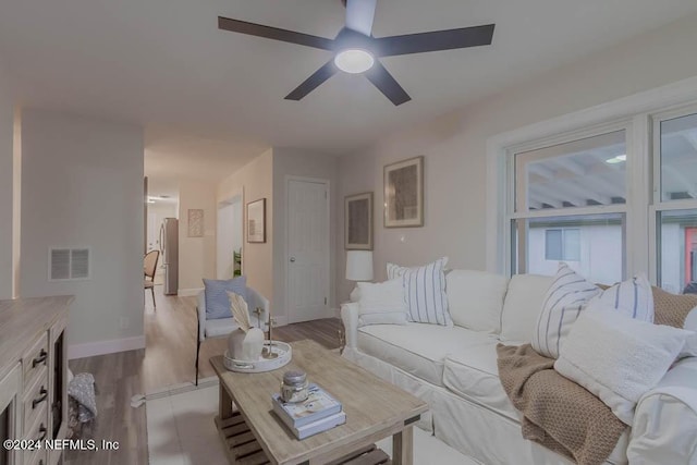 living room with ceiling fan and light wood-type flooring