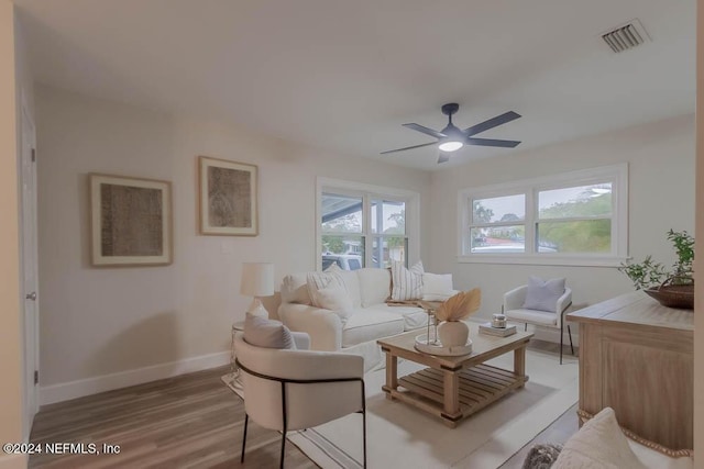 living room featuring wood-type flooring and ceiling fan