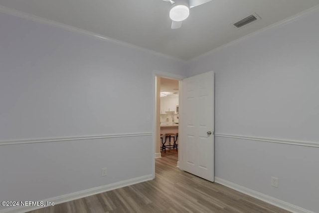 empty room featuring light hardwood / wood-style floors and ornamental molding