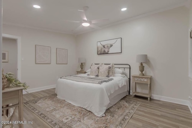 bedroom featuring ceiling fan, wood-type flooring, and ornamental molding