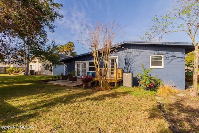 rear view of house with a patio area and a yard