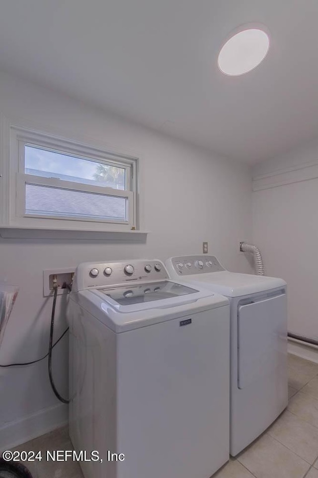 washroom featuring independent washer and dryer and light tile patterned floors