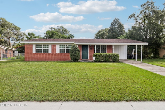 single story home with a front lawn and a carport