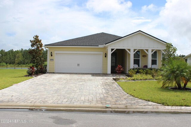 view of front of property with a garage and a front lawn