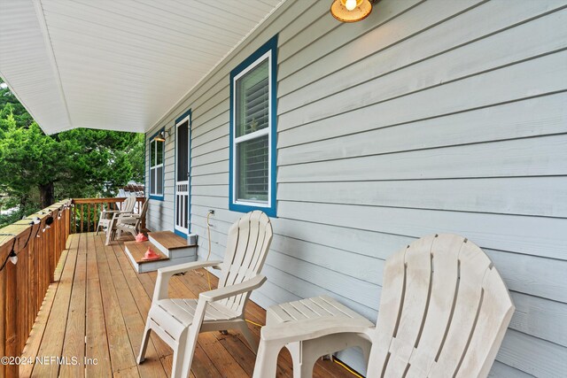 wooden terrace with a porch