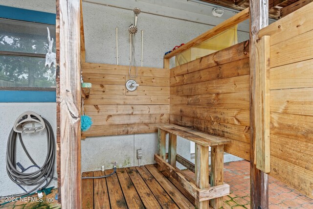 view of sauna featuring wooden walls