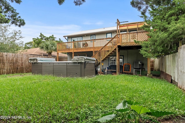 rear view of property featuring a yard and a wooden deck