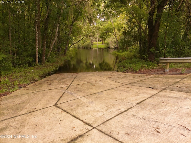 view of patio with a water view