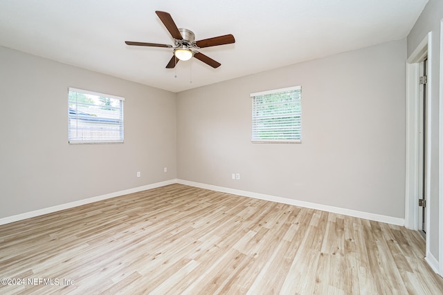 unfurnished room with plenty of natural light, ceiling fan, and light hardwood / wood-style flooring