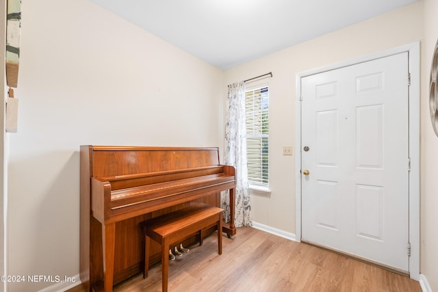 entryway with light wood-type flooring and baseboards