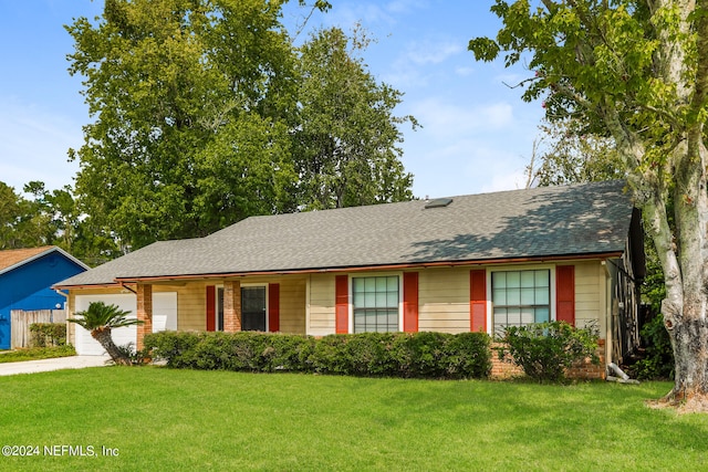 single story home with a garage and a front yard