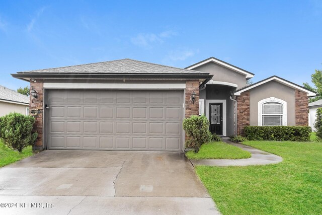 ranch-style house with a front lawn and a garage