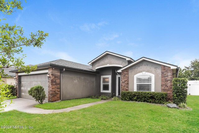 view of front facade featuring a garage and a front lawn