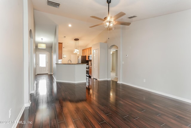 unfurnished living room with ceiling fan, sink, vaulted ceiling, and dark hardwood / wood-style flooring