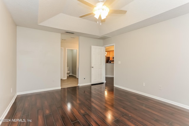 spare room with dark hardwood / wood-style flooring, ceiling fan, and a textured ceiling