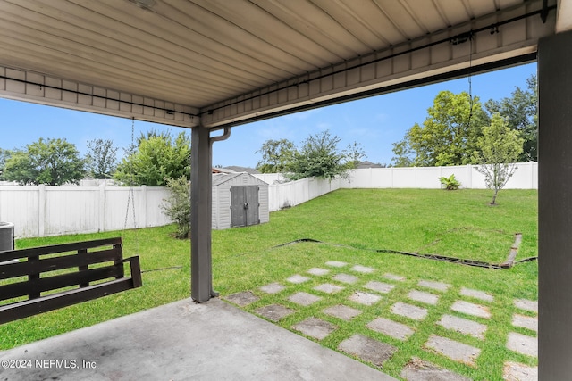 view of yard with a shed and a patio area