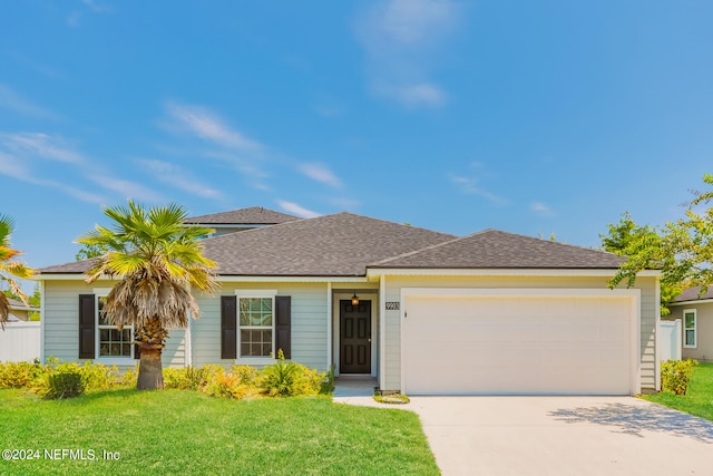 ranch-style house featuring a garage and a front lawn