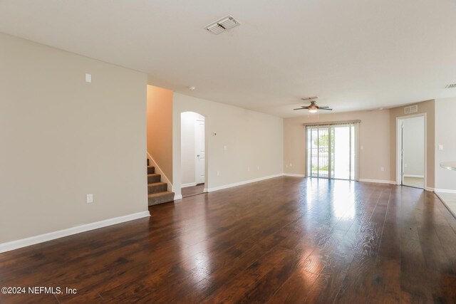 empty room with ceiling fan and dark hardwood / wood-style flooring