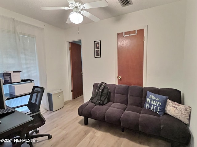 office space featuring a textured ceiling, light hardwood / wood-style flooring, and ceiling fan