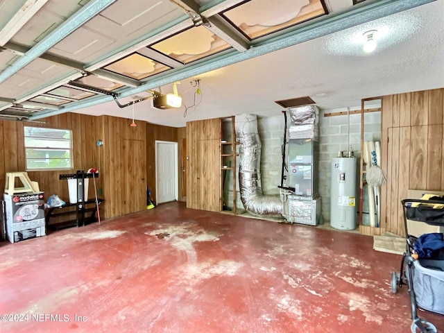 garage featuring a garage door opener, heating unit, and water heater