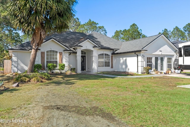 9042 Ford Rd, Bryceville, FL 32009 - view of front facade with french doors, a front yard, and stucco siding