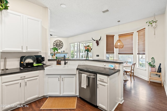 9042 Ford Rd, Bryceville, FL 32009 - kitchen with white cabinets, dishwasher, decorative backsplash, a peninsula, and a textured ceiling