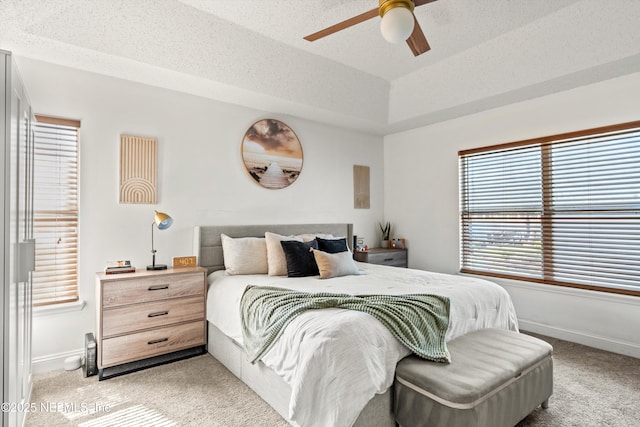 9042 Ford Rd, Bryceville, FL 32009 - bedroom with a raised ceiling, baseboards, light colored carpet, and ceiling fan
