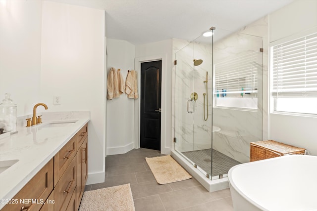 9042 Ford Rd, Bryceville, FL 32009 - bathroom featuring a soaking tub, tile patterned flooring, a marble finish shower, and a sink