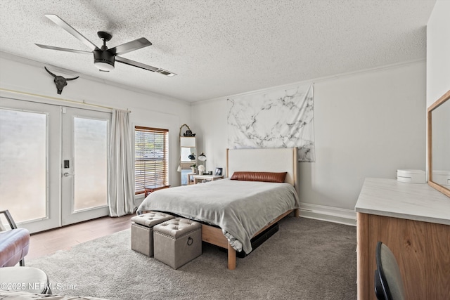 9042 Ford Rd, Bryceville, FL 32009 - bedroom with ceiling fan, french doors, access to exterior, and a textured ceiling