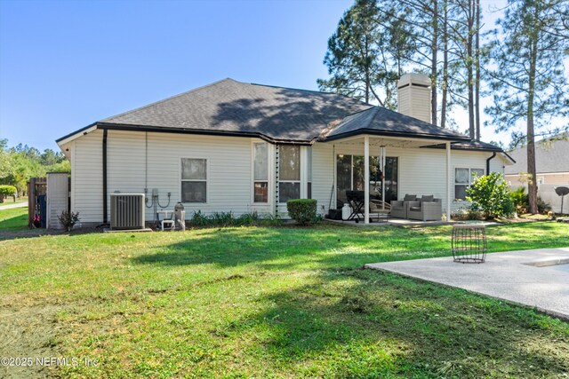 9042 Ford Rd, Bryceville, FL 32009 - rear view of house with an outdoor hangout area, a yard, central AC, and a patio