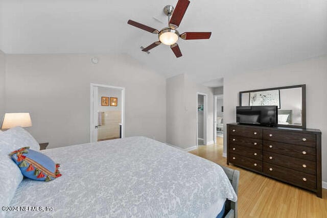 bedroom with lofted ceiling, ceiling fan, ensuite bath, and light hardwood / wood-style floors